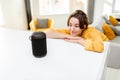 Woman controlling smart home devices with a voice commands