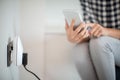 Woman Controlling Smart Plug Using App On Mobile Phone Royalty Free Stock Photo