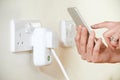 Woman Controlling Smart Plug Using App On Mobile Phone