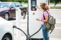 A woman controls a charging station