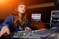 A woman controls the sound mixer. The girl at the remote in the recording Studio. Professional vocal recording at the Studio Royalty Free Stock Photo