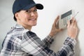 woman controls thermostat