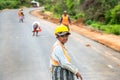 Woman controls traffic on road building site near Yala, Sri Lanka