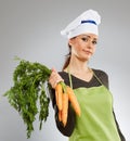 Woman cook with carrots Royalty Free Stock Photo