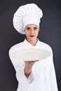 Woman cook or chef serving empty plate Royalty Free Stock Photo