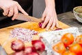 Woman cook cutting red onion Royalty Free Stock Photo