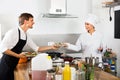 Woman cook giving to waitress ready to serve salad Royalty Free Stock Photo