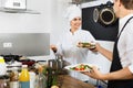 Woman cook giving to waitress ready to serve salad Royalty Free Stock Photo