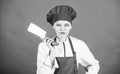 Woman in cook hat and apron. professional chef in kitchen. Cuisine. butcher cut meat. happy woman cooking healthy food Royalty Free Stock Photo