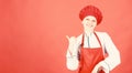 Woman in cook hat and apron. professional chef in kitchen. Cuisine. happy woman cooking healthy food by recipe Royalty Free Stock Photo