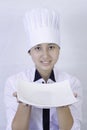 Woman cook holding empty plate