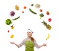 Woman cook juggling with fruits and vegetables Royalty Free Stock Photo