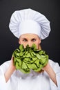 Woman cook with lettuce in her hand standing on black background Royalty Free Stock Photo