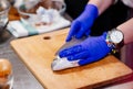 Woman cook preparing and cleaning raw dorada fish Royalty Free Stock Photo