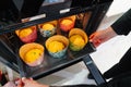 a woman cook puts in the oven dough in paper molds for baking Easter cakes.