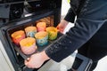 a woman cook puts in the oven dough in paper molds for baking Easter cakes.