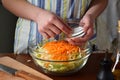 Woman cook sauerkraut or salad on wooden background. Step 3 - Salt the cabbage. Fermented preserved vegetables food concept.