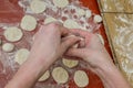 Woman cook sculpts dumplings from flour dough with potatoes