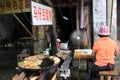 Woman cook on the street. Chikan old town