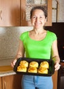 Woman with cooked baked stuffed vegetable marrow