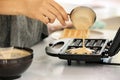 Woman cooking Belgian waffles