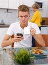 Woman cooking breakfast to her adult son Royalty Free Stock Photo