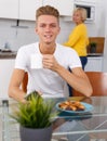 Woman cooking breakfast to her adult son Royalty Free Stock Photo