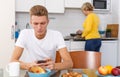 Woman cooking breakfast to her adult son Royalty Free Stock Photo