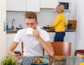 Woman cooking breakfast to her adult son Royalty Free Stock Photo