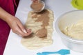 A woman is cooking buns with cinnamon. She rolls the stuffing onto the rolled dough. Mixed sugar and cinnamon. Royalty Free Stock Photo