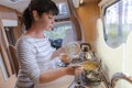 Woman cooking in camper, motorhome interior Royalty Free Stock Photo