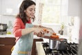 Woman cooking carrots in kitchen for Jewish passover meal Royalty Free Stock Photo