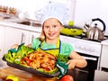 Woman cooking chicken at kitchen.