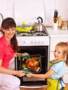 Woman cooking chicken at kitchen. Royalty Free Stock Photo