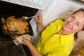 Woman cooking chicken in oven