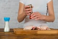 Woman cooking chicken with spicy herbs Royalty Free Stock Photo