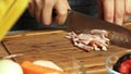 Woman cooking and cutting bacon