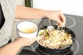 Woman cooking delicious risotto. Tasty recipe