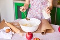 Woman put ingredients for apple pie into big white bowl. Preparing dough in the kitchen Royalty Free Stock Photo