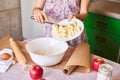 Woman cooking dough for cake, she mixing butter and flour on the bowl on the white table Royalty Free Stock Photo