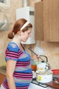 Woman cooking dumplings in the pan