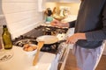 Woman cooking eggs in the kitchen