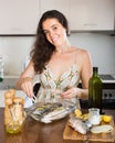 Woman cooking fish at home kitchen Royalty Free Stock Photo