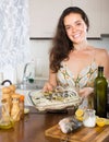 Woman cooking fish at home kitchen Royalty Free Stock Photo