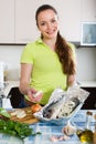 Woman cooking fish at home Royalty Free Stock Photo