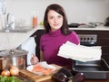 Woman cooking fish pie with store-bought dough