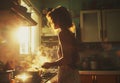 a woman cooking food in the kitchen in front of her,
