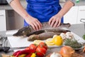 Woman is cooking fresh fish