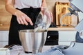 Woman cooking at kitchen and using kitchen machine