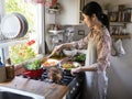 Woman cooking lunch in a kitchen Royalty Free Stock Photo